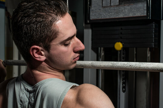 young body builder doing heavy weight exercise for back