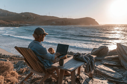 Digital Nomad Working on Laptop by the Sea