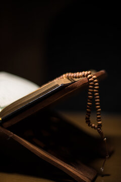 pages of holy koran and rosary at the book