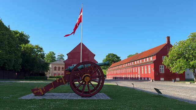 Cannon and flag at historic Kastellet citadel in Copenhagen city, Denmark