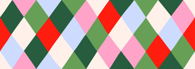 Obraz premium Seamless argyle pattern with geometric rhombus shapes in bright festive colors. Modern textile design for Christmas decoration, wrapping paper and holiday backdrop, vector illustration.