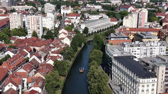 Aerial shot of tourist boat sailing on Ljubljanica river, Slovenia