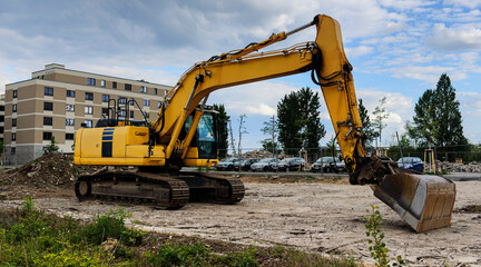 Yellow Excavator Working On Urban Demolition Site © Ionia