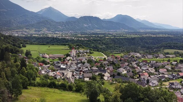 Aerial view of Rodine village and church with Alps background, Slovenia