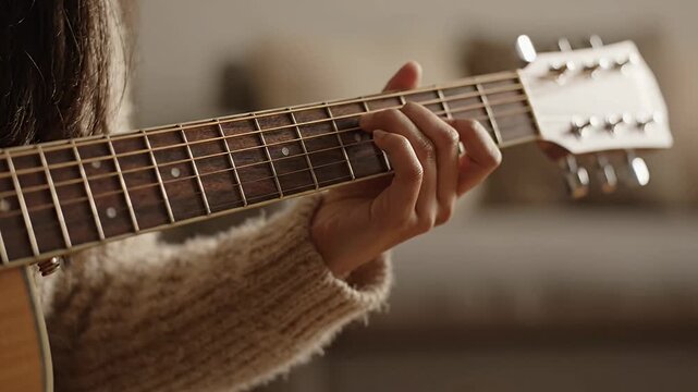 Close up of musician hands playing acoustic guitar.