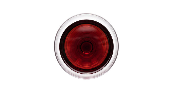 Top view of a glass filled with swirling red wine on a white background
