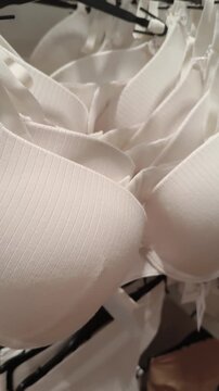  White bra lingerie hanging on rack inside clothing store