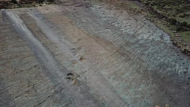 Drone view approaching fossilized dinosaur footprints at Ni&ntilde;u Mayu Bolivia 