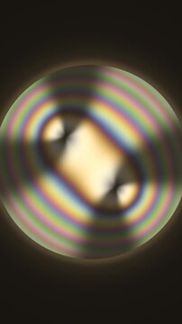 Conoscopic Interference Figure With Swinging Isogyre Brushes In Polarized Light Seamless Loop in subtle amber tones vertical 9:16