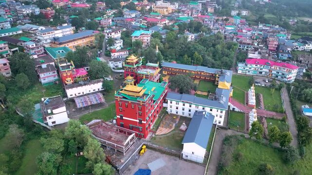 Cinematic drone pullback revealing the majestic Tibetan monastery and surrounding hill town in Bir, Himachal Pradesh
