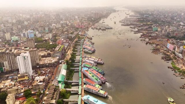 Aerial drone view of Sadarghat river port with passenger boats and dense Dhaka city