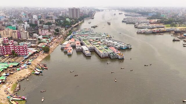 Aerial drone view of Sadarghat river port with passenger boats and dense Dhaka city