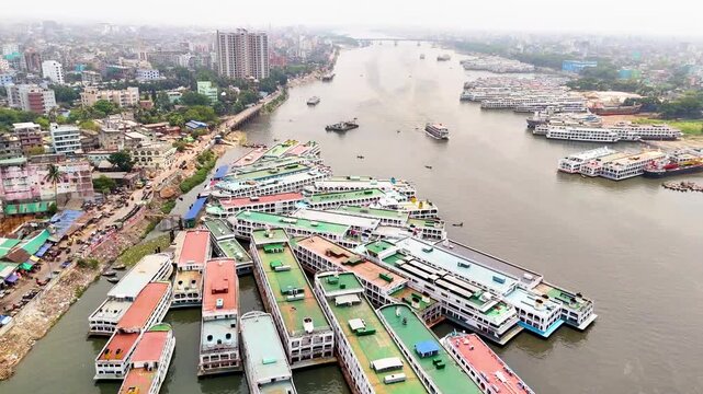 Aerial drone view of Sadarghat river port with passenger boats and dense Dhaka city
