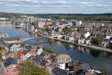 Fototapeta premium River winds through historic town with red-tiled roofs namur belgium
