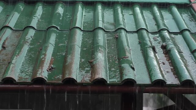 Rain sheeting down a copper roof