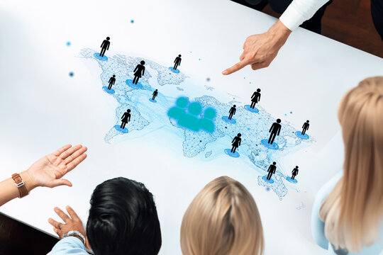 Collaborative Team Meeting Around Virtual World Map with Abstract People Icons and Digital Interface Representing Global Connections and Networking Opportunities. Entropy.