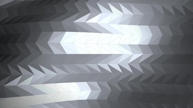Abstract geometric background with a low poly pattern of triangles in shades of gray, creating a modern and sleek metallic texture with a wavy, flowing visual effect