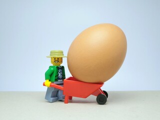 Obraz premium Indonesia - November 17, 2023 : Mini toy figure at table with blurred background. Farm product concept design.