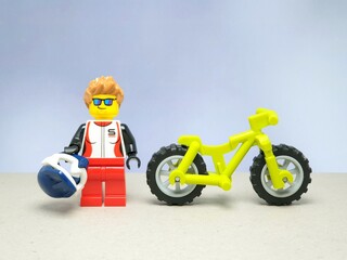 Fototapeta premium Indonesia - November 13, 2023 : Mini toy of lego at table with blurred background. Bicycle concept design.