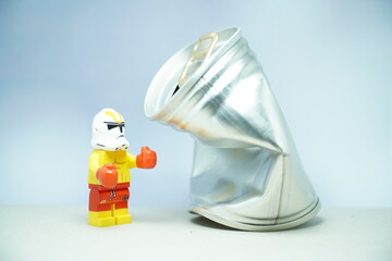 Fototapeta premium Indonesia - November 10, 2023 : Mini toy figure of lego at table with blurred background. Boxing man hit the sack concept design. Stormtrooper character from Star Wars film.