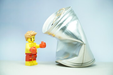 Fototapeta premium Indonesia - November 10, 2023 : Mini toy of lego at table with blurred background. Boxing man hit the sack concept design.