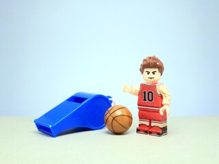 Fototapeta premium Indonesia - March 22, 2024 : Mini toy of action figure with blurred background. Toy photography concept design. Basketball player conceptual design.