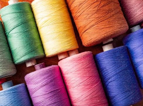 Photo of various colored cotton threads laying on table.
