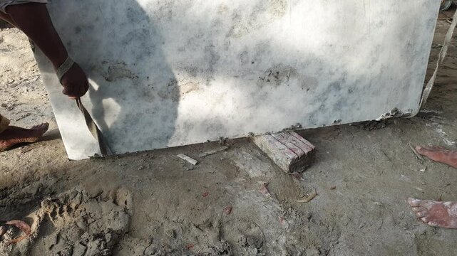 Workers Lifting Heavy Marble Slab at Construction Site