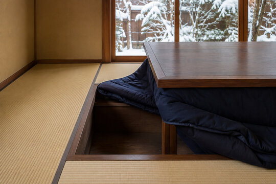 Japanese horigotatsu with recessed footwell beside a snowy garden