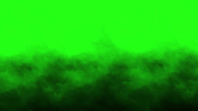 Dark heavy smoke and rolling fog creeping on ground on green screen
