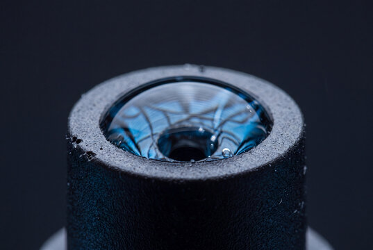 Curved meniscus water surface tension at drip emitter hole extreme macro