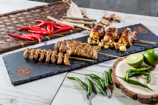 Grilled chicken gizzard and squid skewers