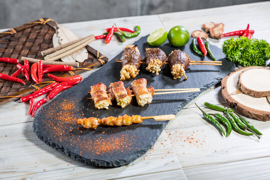 Assorted grilled skewers with chili garnish