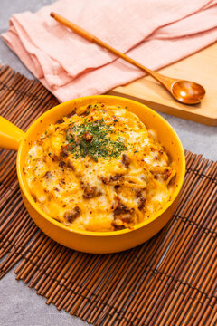 Cheesy baked pasta in yellow pan