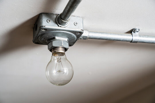 Pendent fire sprinkler head mounted on ceiling with metal conduit