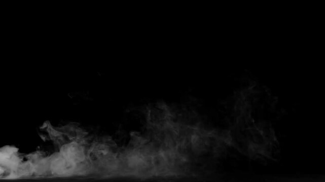 White smoke swirls gently across the bottom section of a solid black backdrop with ample copy space.