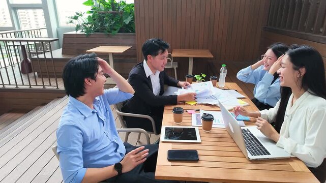 Asian Business Team Celebrating Success with High Fives on Office Terrace