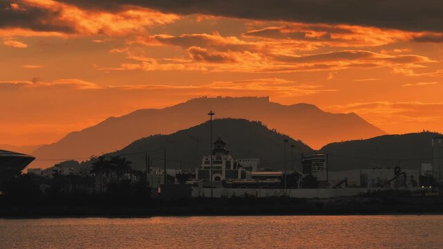 Ba Na Hills Mountain Silhouette far in the distance Over Han River Bay at Golden Sunset