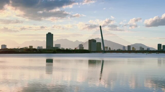 Tran Thi Ly Bridge and City Skyline Reflected in Han River at sunset