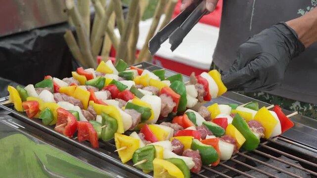 Colorful vegetable skewers cooking on a barbecue grill
