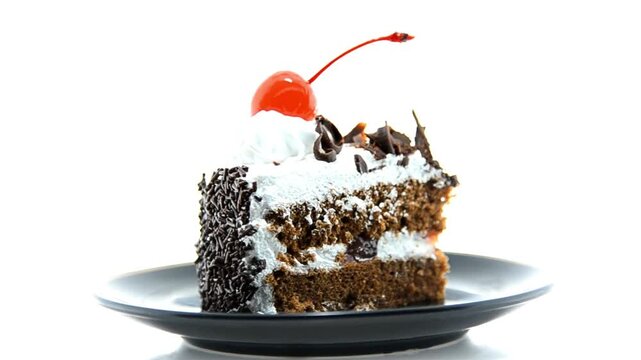 A slice of delicious black forest cake isolated on white background