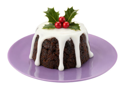 Christmas fruit cake with white icing and holly berries on a plate as isolated on transparent background