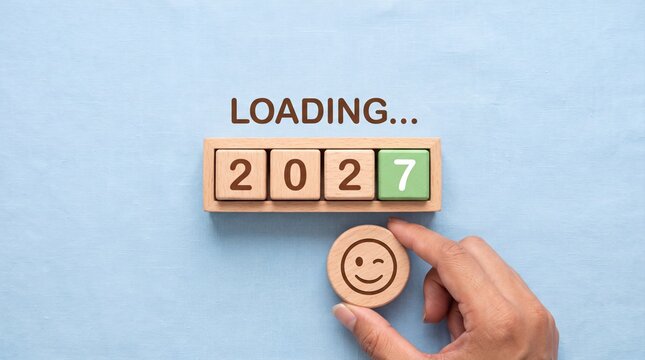 Wooden blocks forming 2027 loading progress bar with a winking smiley