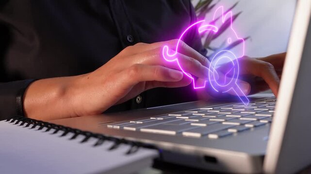Money management. Close-up of a businesswoman's hands working on her computer with a virtual piggy bank icon and a magnifying glass.