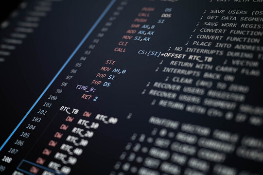 Close-up of low-level programming code displayed on a dark computer screen, highlighting software development, assembly language, debugging, computer engineering, and technical programming.