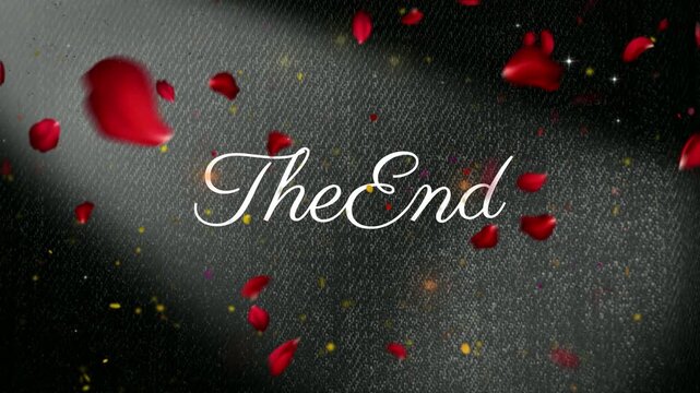 Text stating the end placed centrally amidst falling red rose petals over dark fabric texture background.