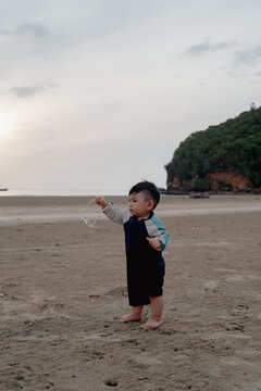 little boy playing on the beach