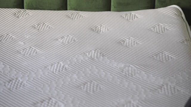Cleaning a mattress with a vacuum at home in the living room