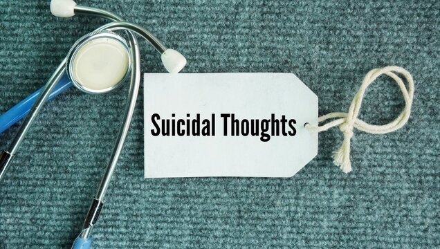 Stethoscope and paper tag with the word Suicidal thoughts. thoughts, ideas, or fantasies about wanting to end your life, wishing you were dead, or feeling that others would be better off without you.