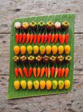 Luk chup, Thai mung bean sweets shaped as miniature fruits arranged on banana leaf, top view